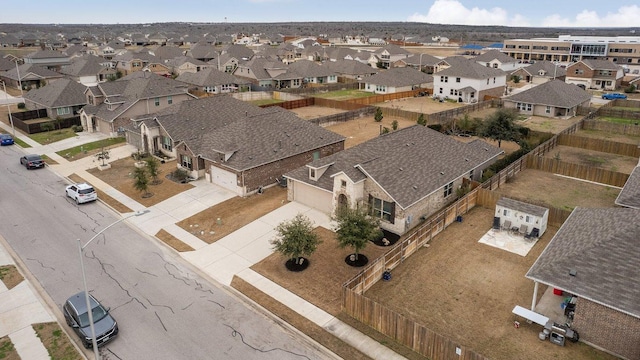 birds eye view of property with a residential view