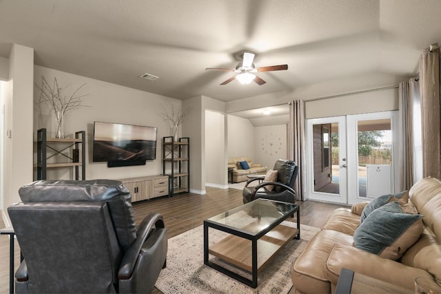 living area with ceiling fan, dark wood-type flooring, visible vents, baseboards, and french doors