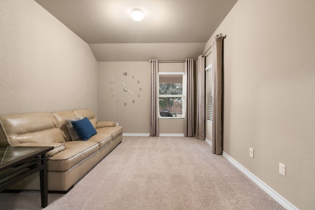 living room featuring light carpet, vaulted ceiling, a textured ceiling, and baseboards