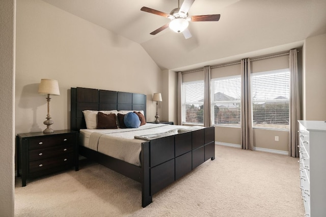 bedroom featuring lofted ceiling, ceiling fan, baseboards, and light colored carpet