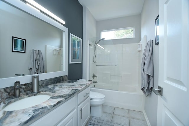 bathroom featuring toilet, washtub / shower combination, vanity, tile patterned flooring, and baseboards