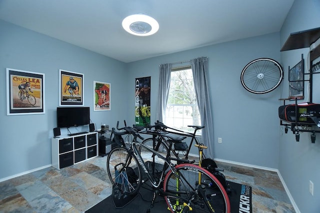 game room with stone finish flooring and baseboards