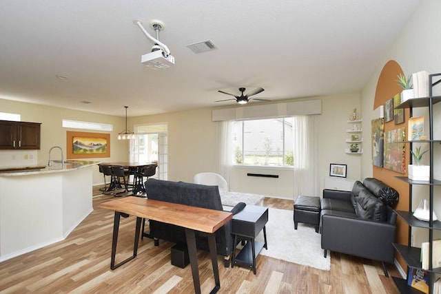 dining room with plenty of natural light, visible vents, and light wood-style floors