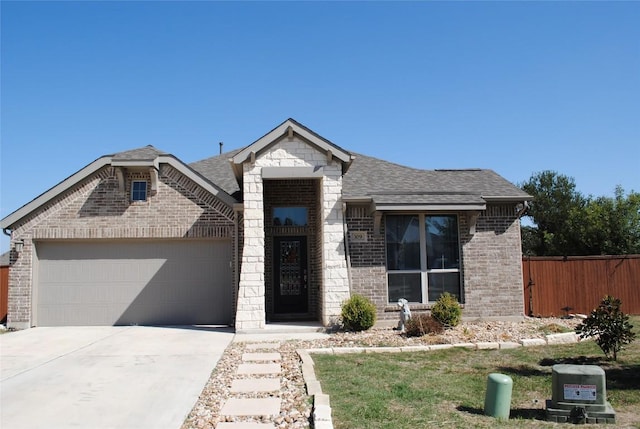 view of front of home featuring brick siding, a shingled roof, fence, a garage, and driveway