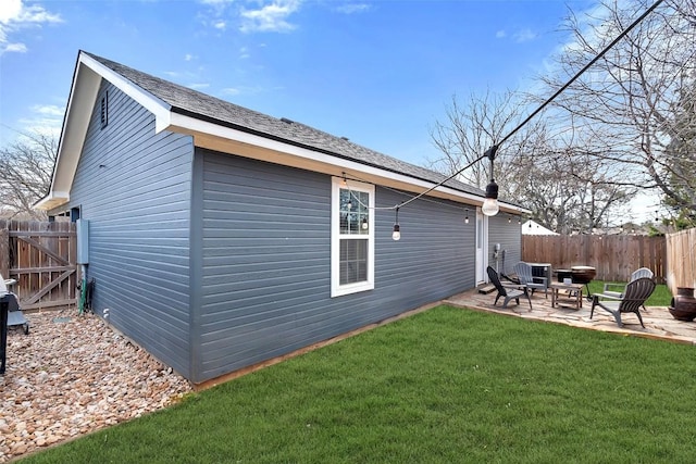 back of property featuring a patio, a yard, and fence