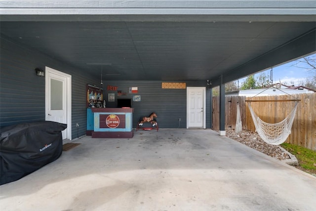 exterior space featuring a carport and fence