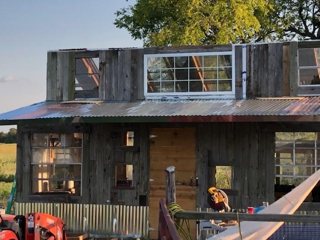 rear view of house featuring metal roof