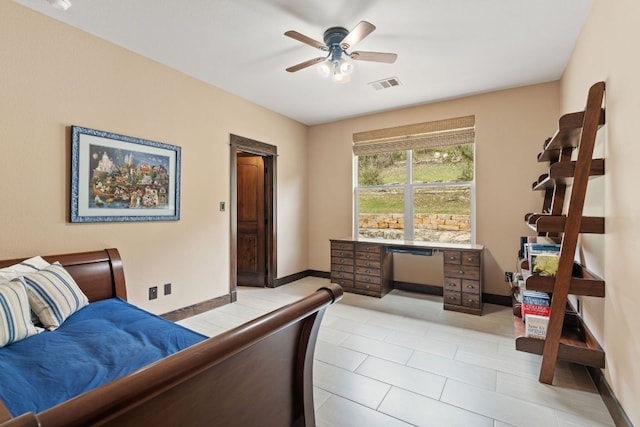 bedroom with visible vents, baseboards, built in desk, and a ceiling fan