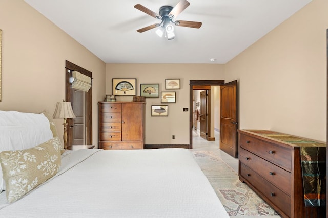 bedroom featuring baseboards and ceiling fan