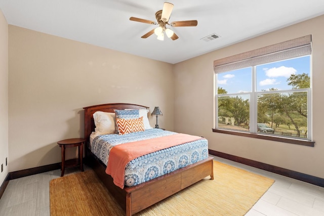 bedroom with a ceiling fan, baseboards, and visible vents