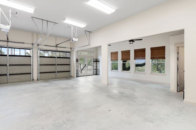 garage featuring a garage door opener and baseboards