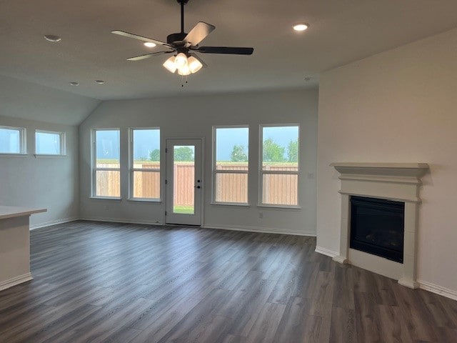 525 Teasley Dr, Taylor, TX 76574 - unfurnished living room with plenty of natural light, dark wood-style flooring, a fireplace, recessed lighting, and vaulted ceiling