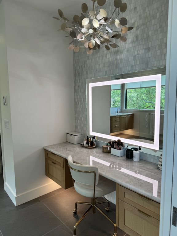 tiled office space featuring a chandelier, built in study area, baseboards, and a sink