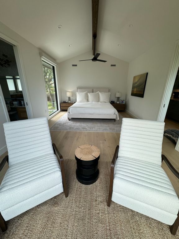 bedroom with visible vents, lofted ceiling with beams, and wood finished floors