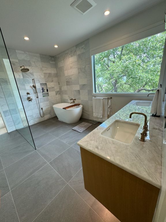 212 Westhaven Dr, West Lake Hills, TX 78746 - full bath with tile walls, double vanity, walk in shower, tile patterned flooring, and a freestanding bath