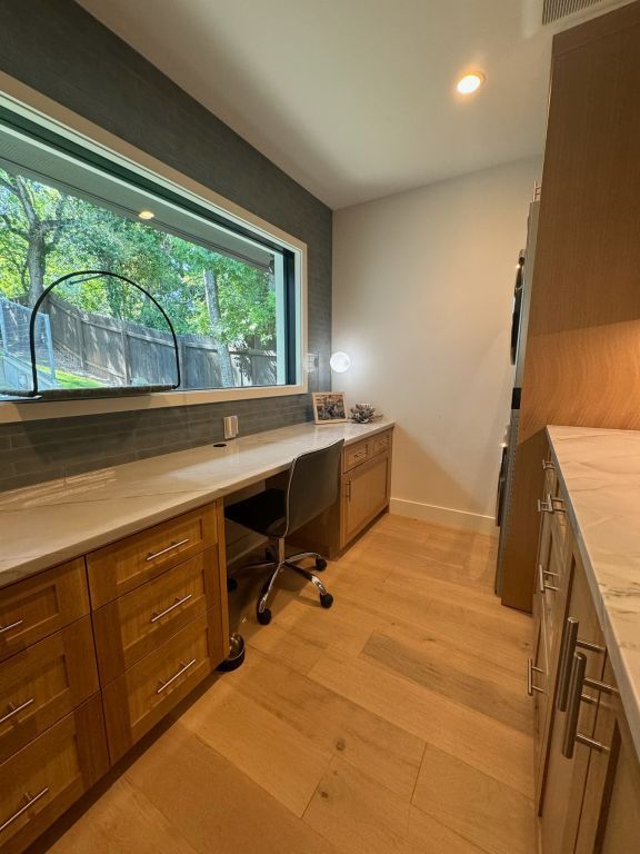 office space with baseboards, recessed lighting, built in study area, and light wood-style floors