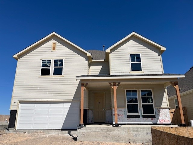 view of front of house with a porch and an attached garage