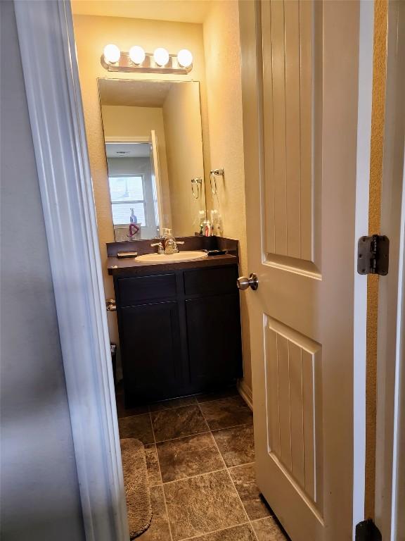 bathroom with vanity and stone finish flooring