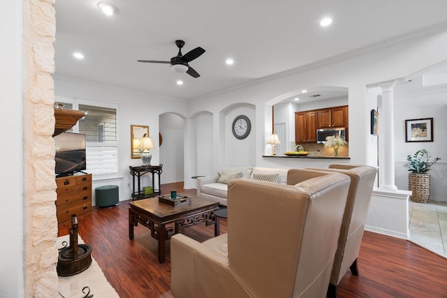 living area with ornamental molding, ornate columns, recessed lighting, wood finished floors, and a ceiling fan