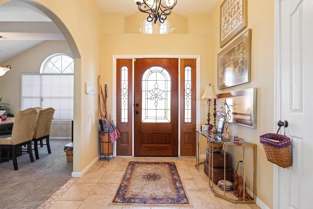 20531 Highland Lake Dr, Lago Vista, TX 78645 - entryway featuring arched walkways, lofted ceiling, a chandelier, and light carpet