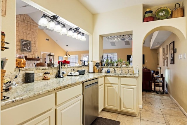 20531 Highland Lake Dr, Lago Vista, TX 78645 - kitchen with dishwasher, lofted ceiling, light stone counters, backsplash, and light tile patterned floors