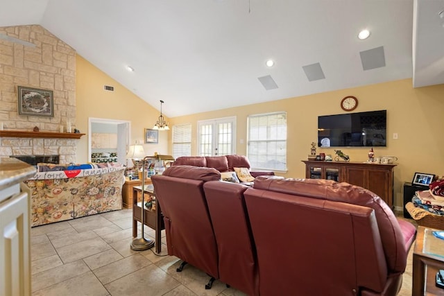 20531 Highland Lake Dr, Lago Vista, TX 78645 - living area with a fireplace, high vaulted ceiling, a chandelier, and light tile patterned floors