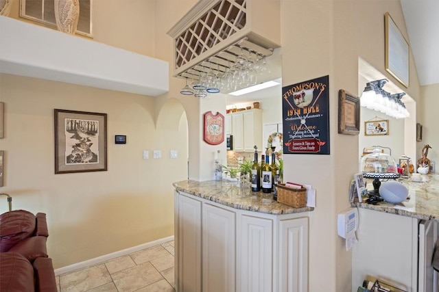 20531 Highland Lake Dr, Lago Vista, TX 78645 - bar area with arched walkways and light tile patterned flooring