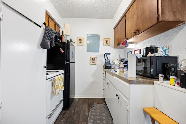 2803 Hemphill Park Unit B310, Austin, TX 78705 - kitchen featuring electric panel, a textured ceiling, brown cabinetry, dark wood-type flooring, and black appliances