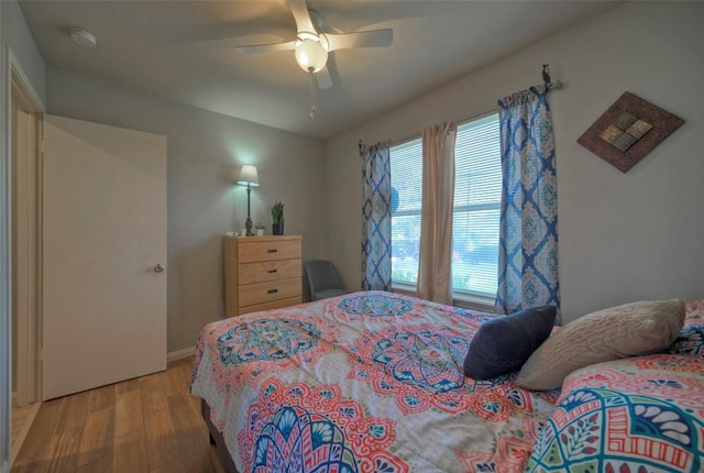 bedroom with light wood-style floors and a ceiling fan