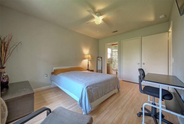 bedroom with light wood-type flooring, visible vents, ensuite bathroom, baseboards, and ceiling fan