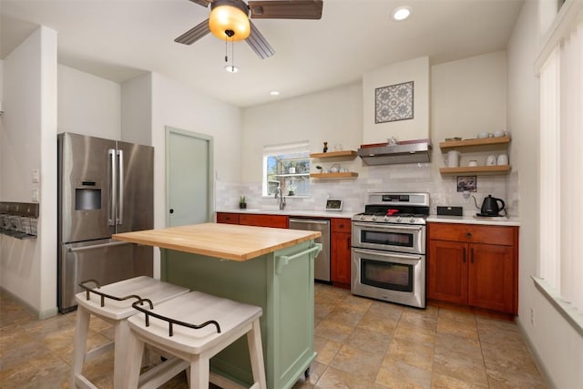 kitchen with open shelves, under cabinet range hood, wood counters, tasteful backsplash, and stainless steel appliances