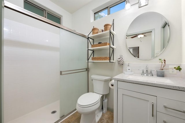 full bath featuring vanity, toilet, a stall shower, and ceiling fan