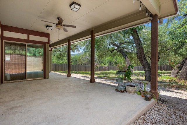 view of patio featuring ceiling fan and fence