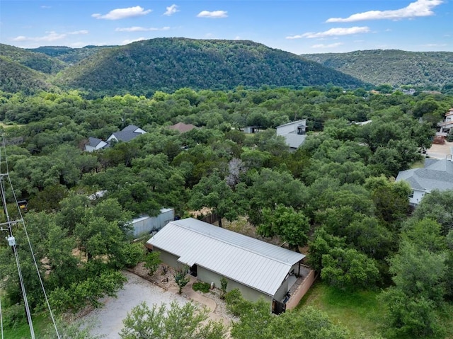 birds eye view of property with a mountain view and a view of trees