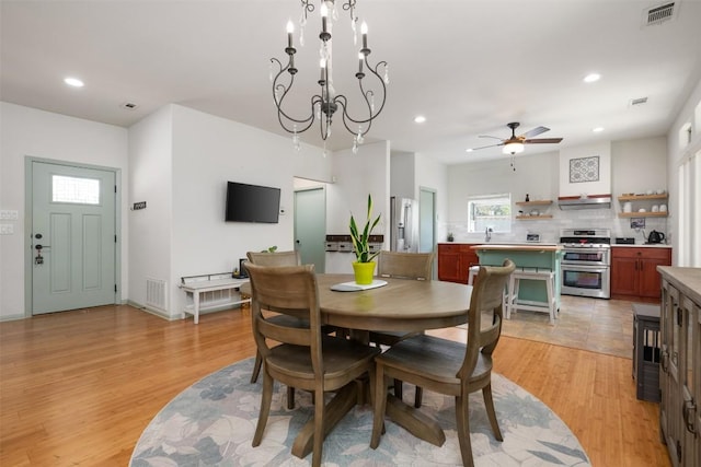 dining area featuring visible vents, recessed lighting, ceiling fan with notable chandelier, and light wood-style floors