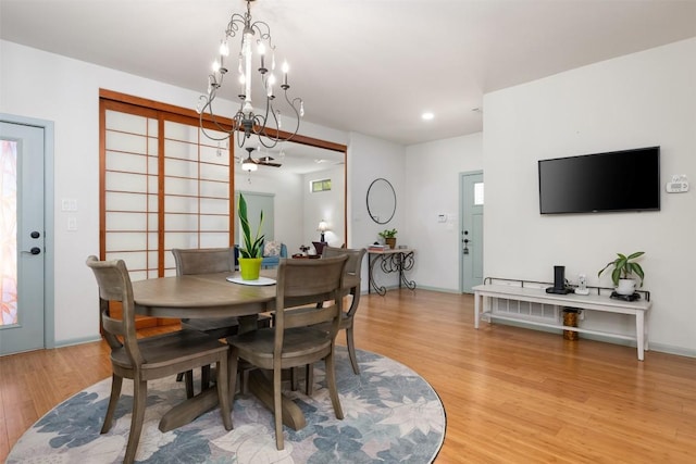 dining area featuring recessed lighting, an inviting chandelier, and light wood finished floors