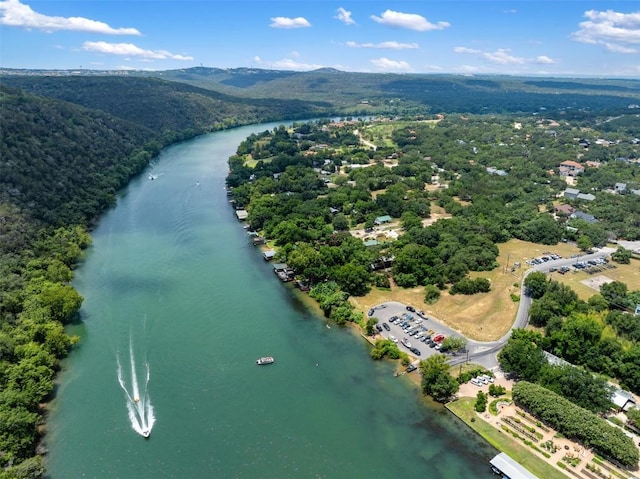 aerial view with a forest view and a water view