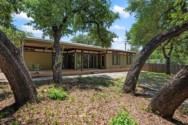 back of property with a patio and fence