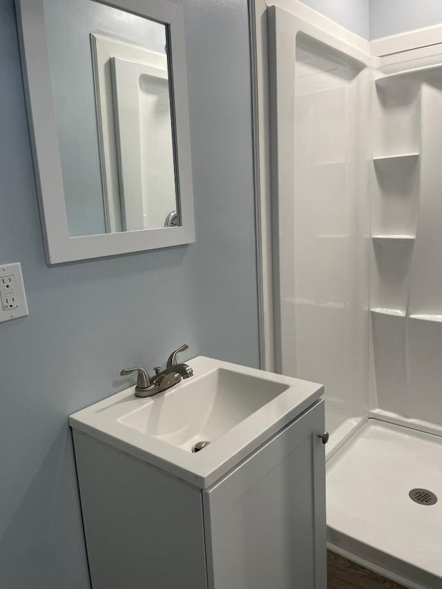 full bathroom featuring vanity and a shower stall