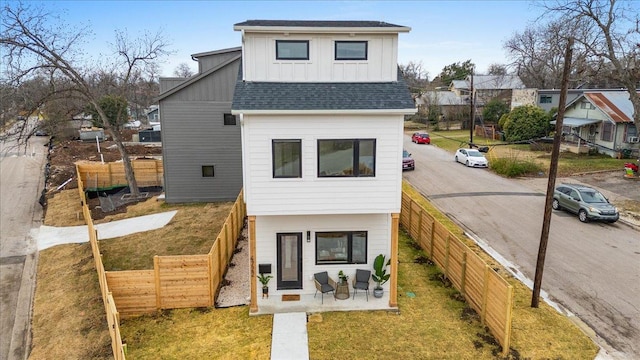 204 Pecan Dr Unit 2, Austin, TX 78753 - rear view of property featuring board and batten siding, a shingled roof, and a fenced backyard