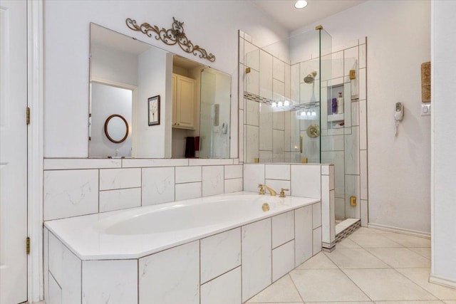 bathroom featuring tile patterned flooring, a garden tub, and a stall shower