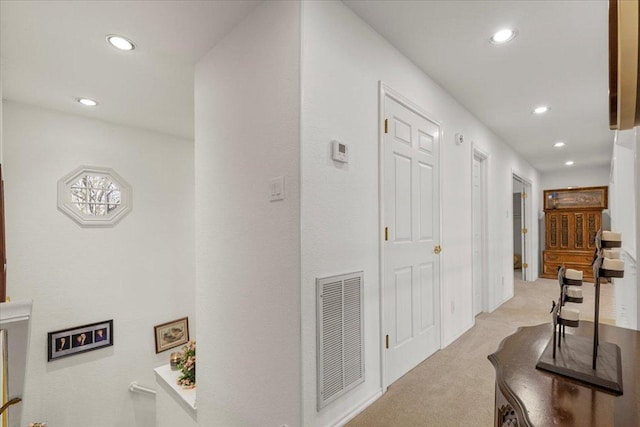 corridor featuring recessed lighting, visible vents, and light carpet