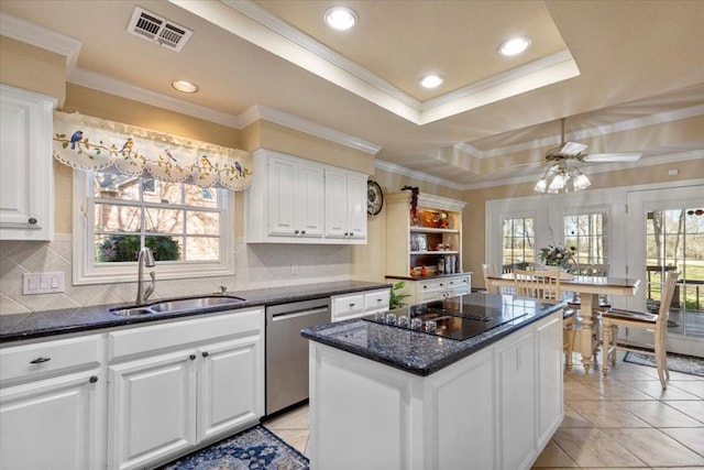 kitchen featuring visible vents, a kitchen island, a sink, stainless steel dishwasher, and a raised ceiling