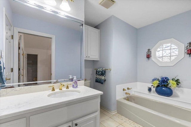 full bath with a bath, vanity, and tile patterned flooring