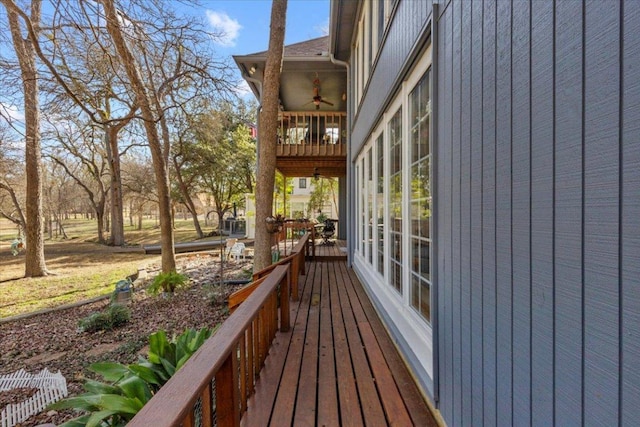 wooden terrace with a ceiling fan