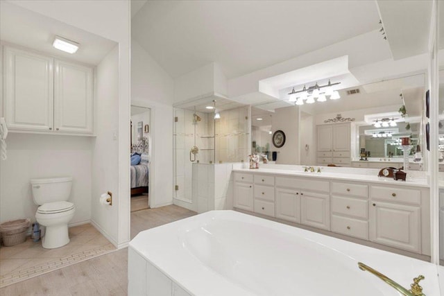 bathroom with vanity, visible vents, lofted ceiling, a tile shower, and a bathtub