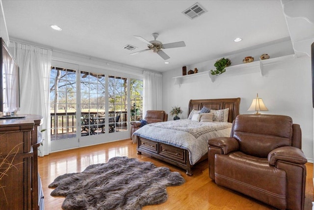 bedroom with visible vents, light wood-style flooring, a ceiling fan, and access to outside