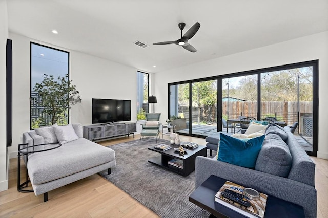 living room with recessed lighting, visible vents, wood finished floors, and a ceiling fan