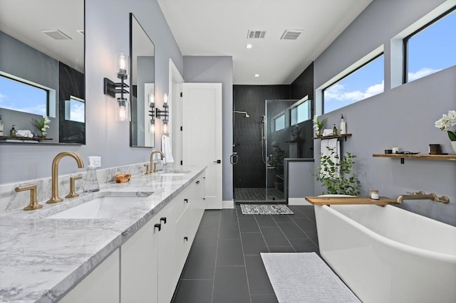 bathroom featuring a sink, visible vents, and a stall shower