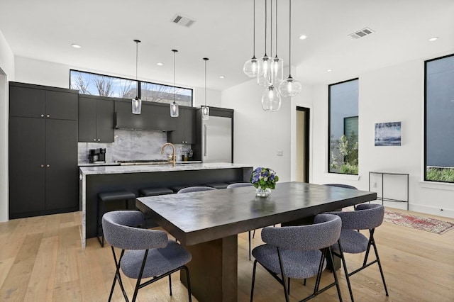 dining space with recessed lighting, light wood-style floors, and visible vents